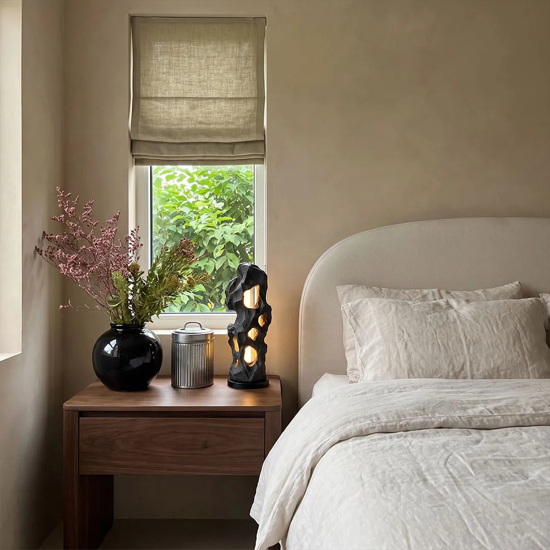 Artistic table lamps displayed on a nightstand in a calm modern bedroom.