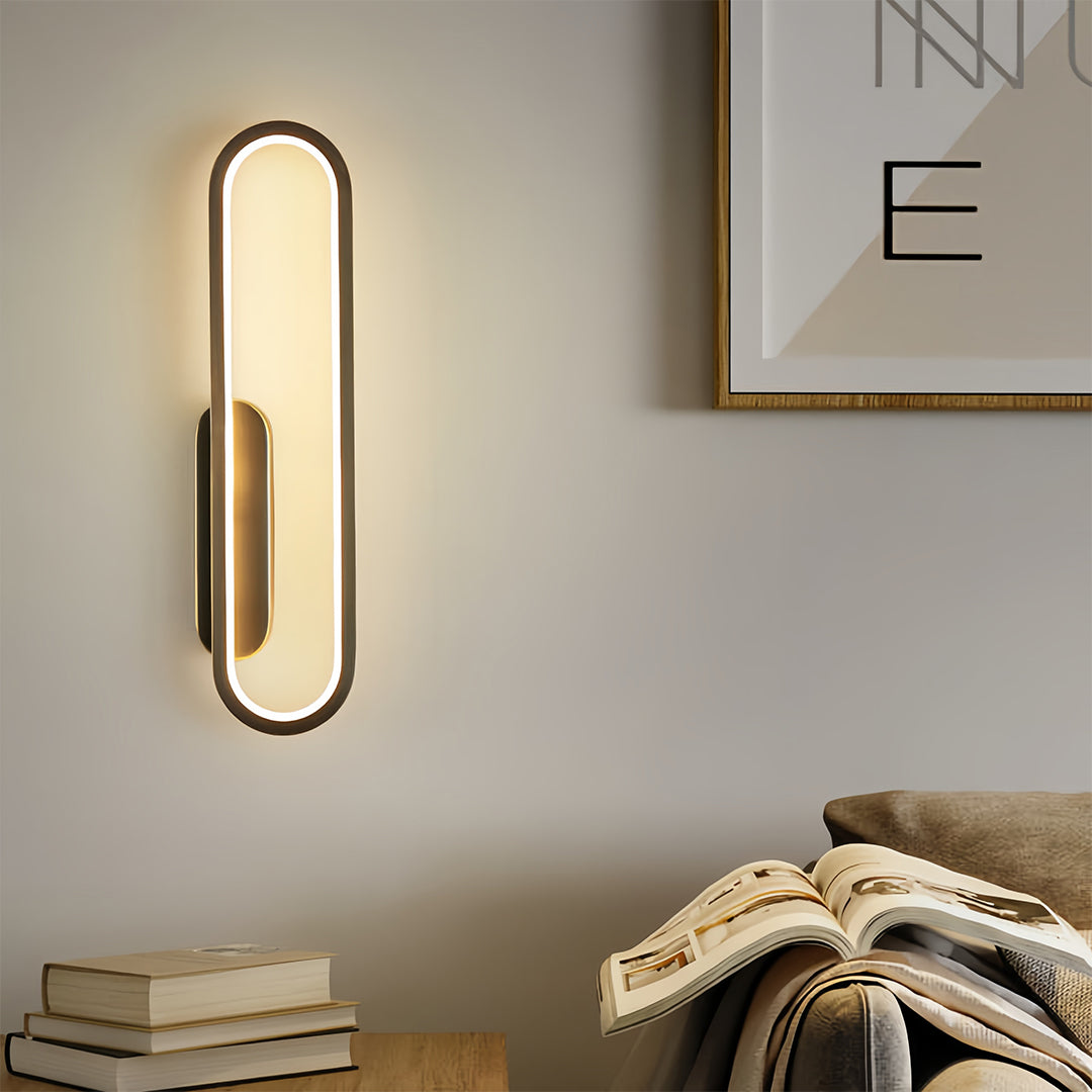 Sophisticated wall pack LED light with golden frame installed beside artwork display