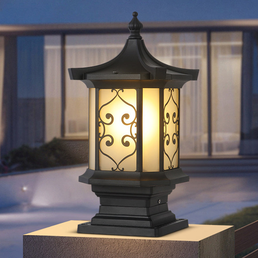 Traditional Asian-inspired post lantern with decorative scrollwork and warm amber glass panels