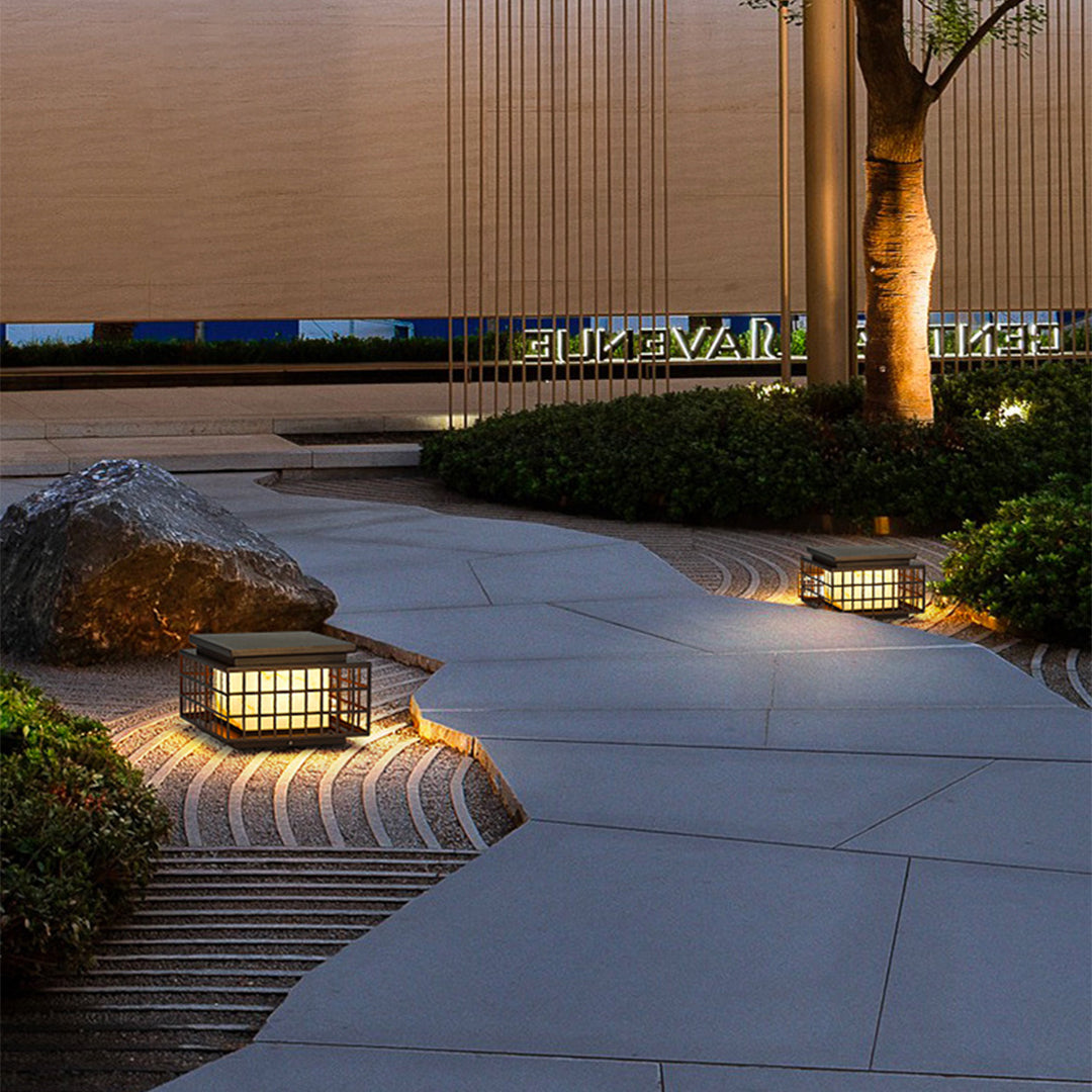 Asian-inspired solar pathway lights installed along modern concrete walkway creating elegant evening ambiance in landscape