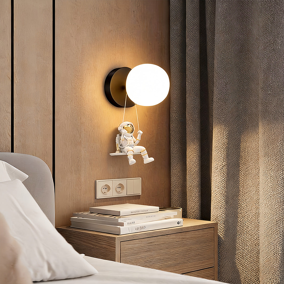 Astronaut wall light casting a warm glow in a cozy bedroom with wooden accents.