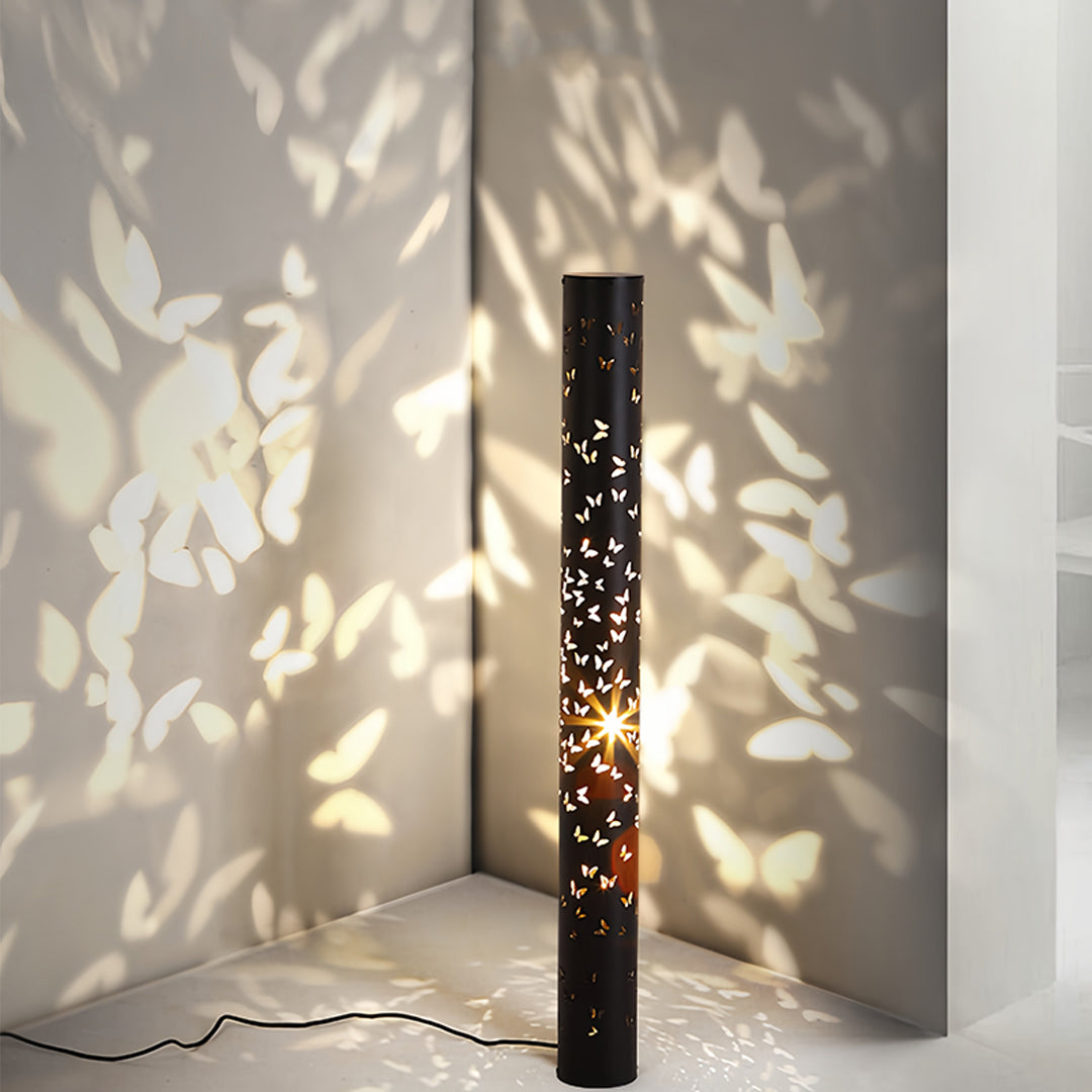 Designer small black pendant light creating atmospheric mood lighting with delicate cutout shadows