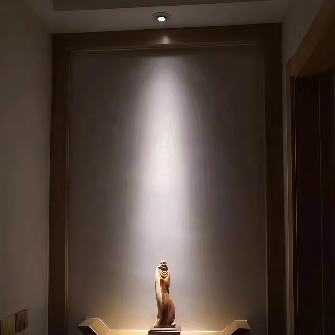 Atmospheric indoor spotlights creating dramatic effect in dark corridor with glass shade chandelier style focused beams.