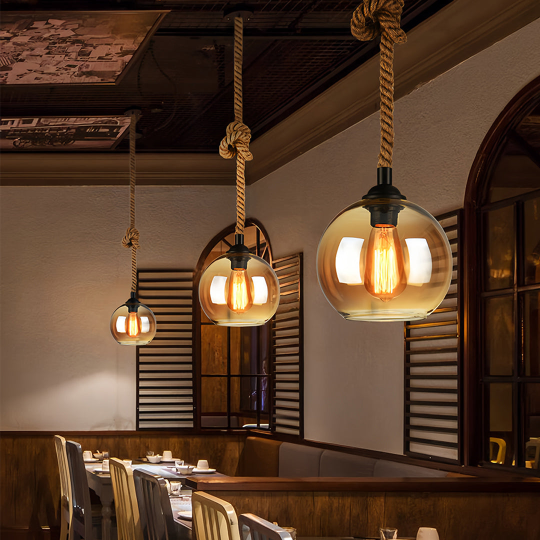 Atmospheric retro glass pendant lights illuminating rustic dining space with vintage charm