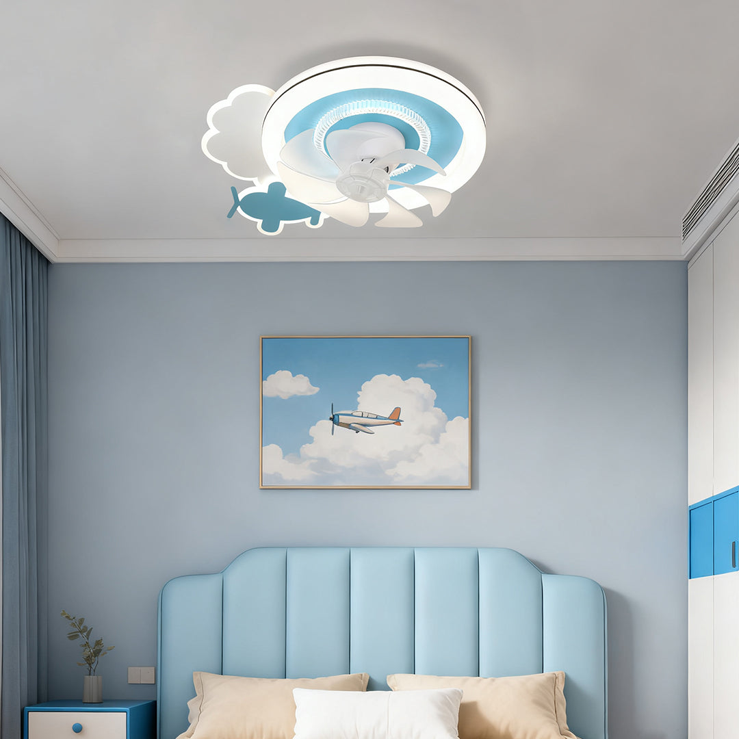 Aviation-themed white and blue children's ceiling fans with lights installed in a boy's bedroom with a soft blue headboard and airplane decor. 