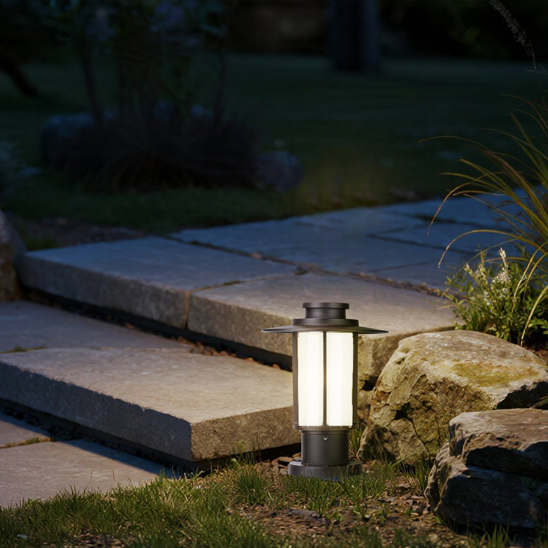 Classic outdoor lantern post lights lining a landscaped garden path at dusk