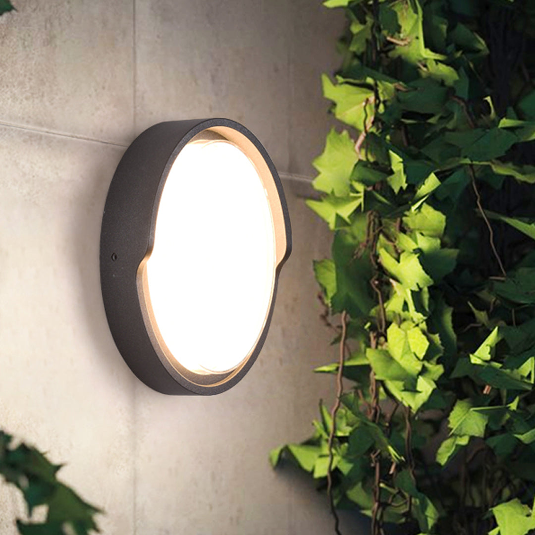 Modern black circular wall light with white LED panel for contemporary interior applications