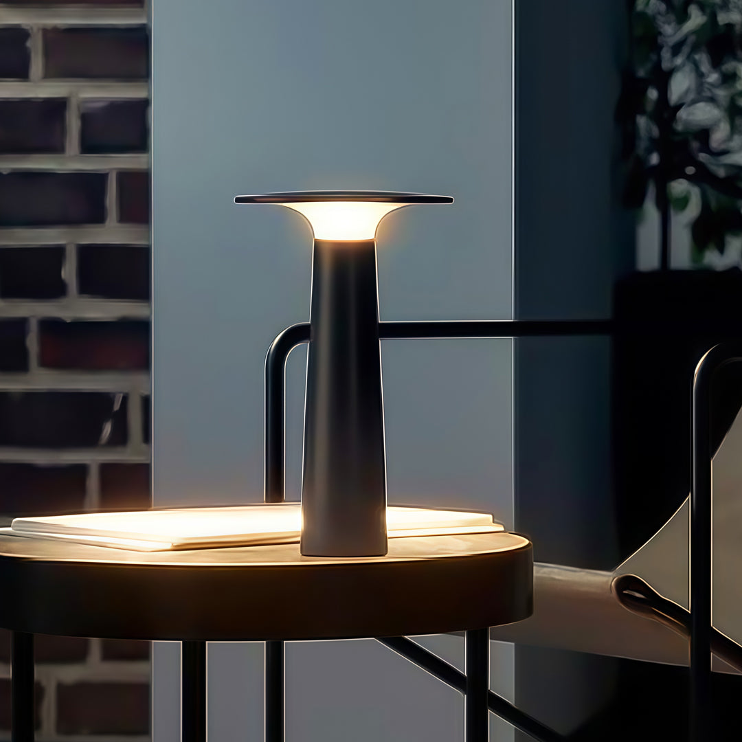 Modern outdoor led table lamp on balcony table providing soft evening illumination.