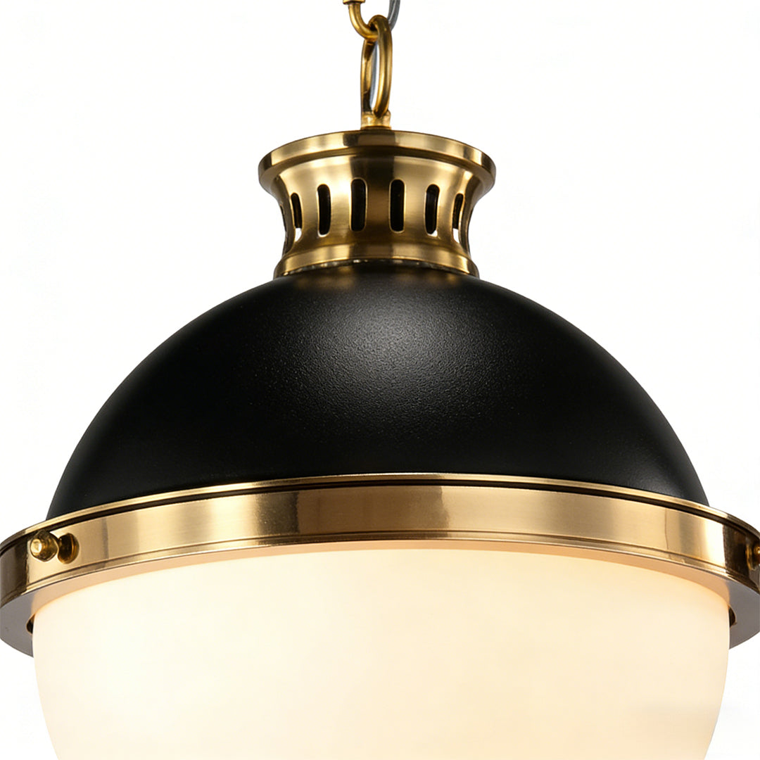 Elegant ball pendant light in black and gold design, showcasing a smooth glass sphere and metallic details for modern ceiling lighting.
