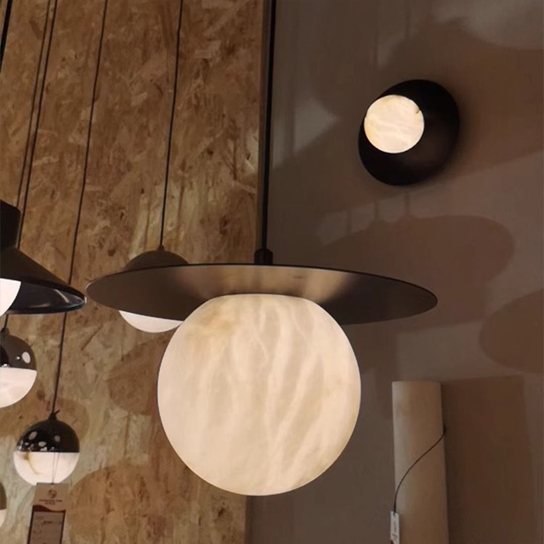 Ball pendant light with a white marble sphere, creating a stylish focal point in a modern interior.