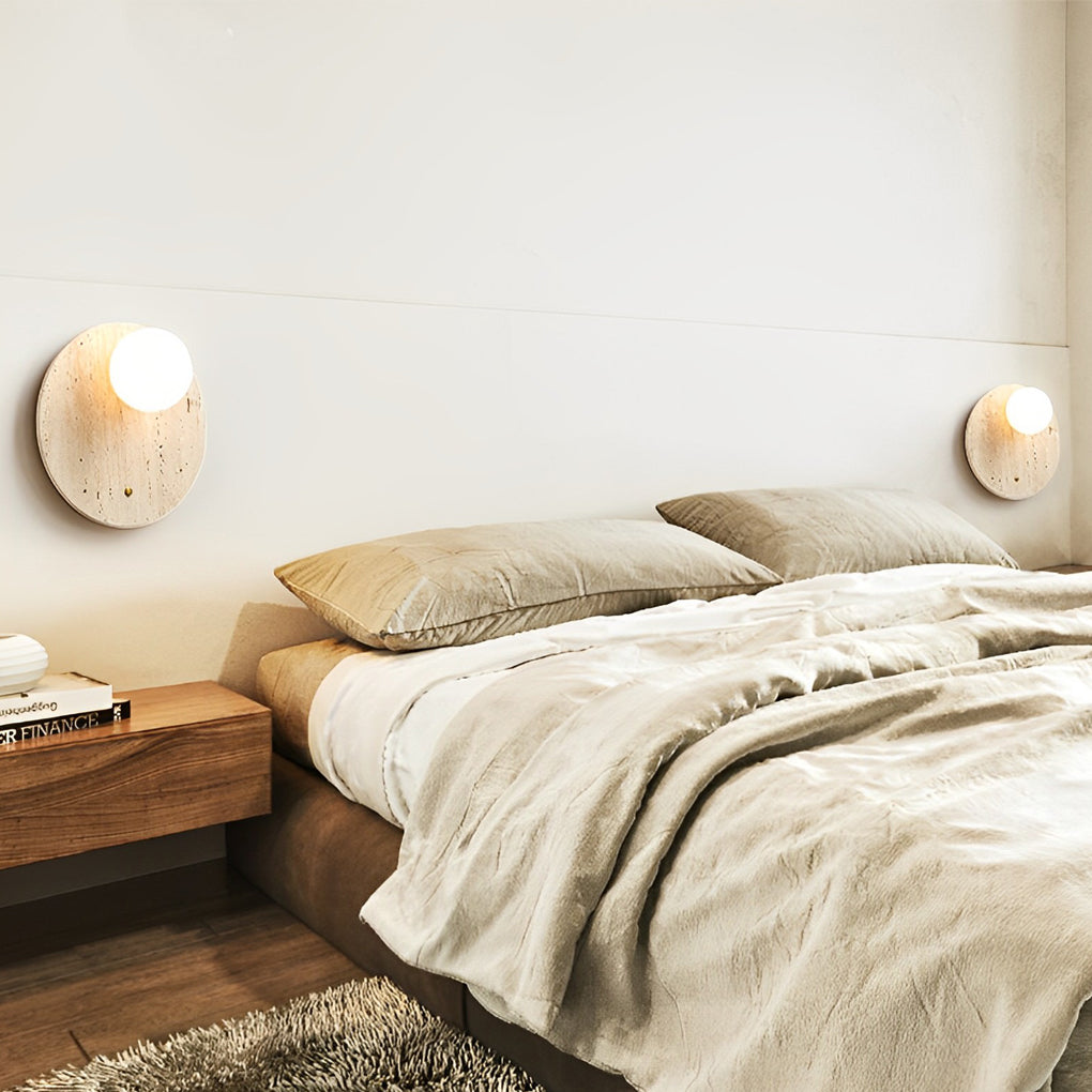 Ball wall lamp with a minimalist design, illuminating a contemporary bedroom.