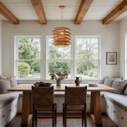 Bamboo pendant lights with a layered design, hanging above a rustic dining area.