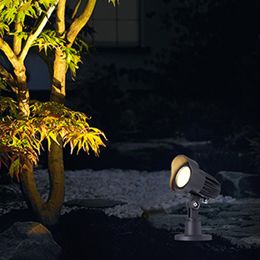 Dramatic uplighting of bamboo and tropical plants creating ambient outdoor atmosphere