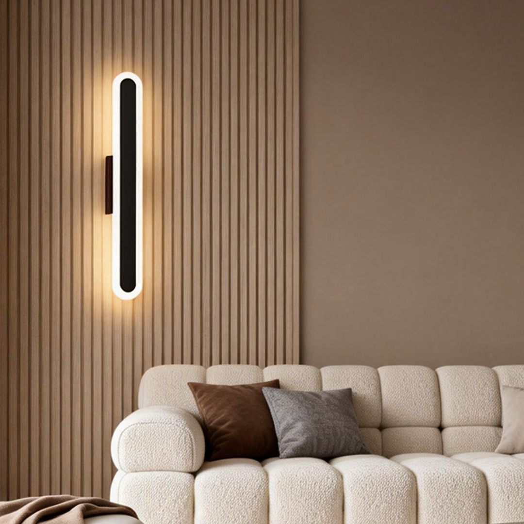 Bar wall light adding a warm glow to a cozy living room with wooden accents.