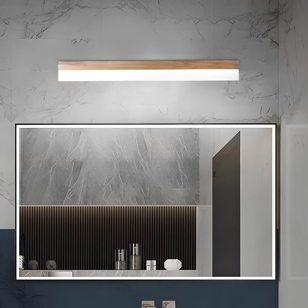 Bath bar vanity light with a close-up of its elegant light bar above a large mirror.