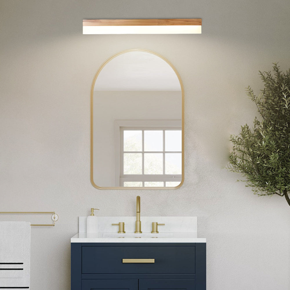 Bath bar vanity light with a modern design, illuminating a bathroom with a navy vanity.