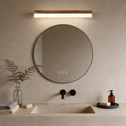 Bath bar vanity light with a sleek design, illuminating a modern round bathroom mirror.