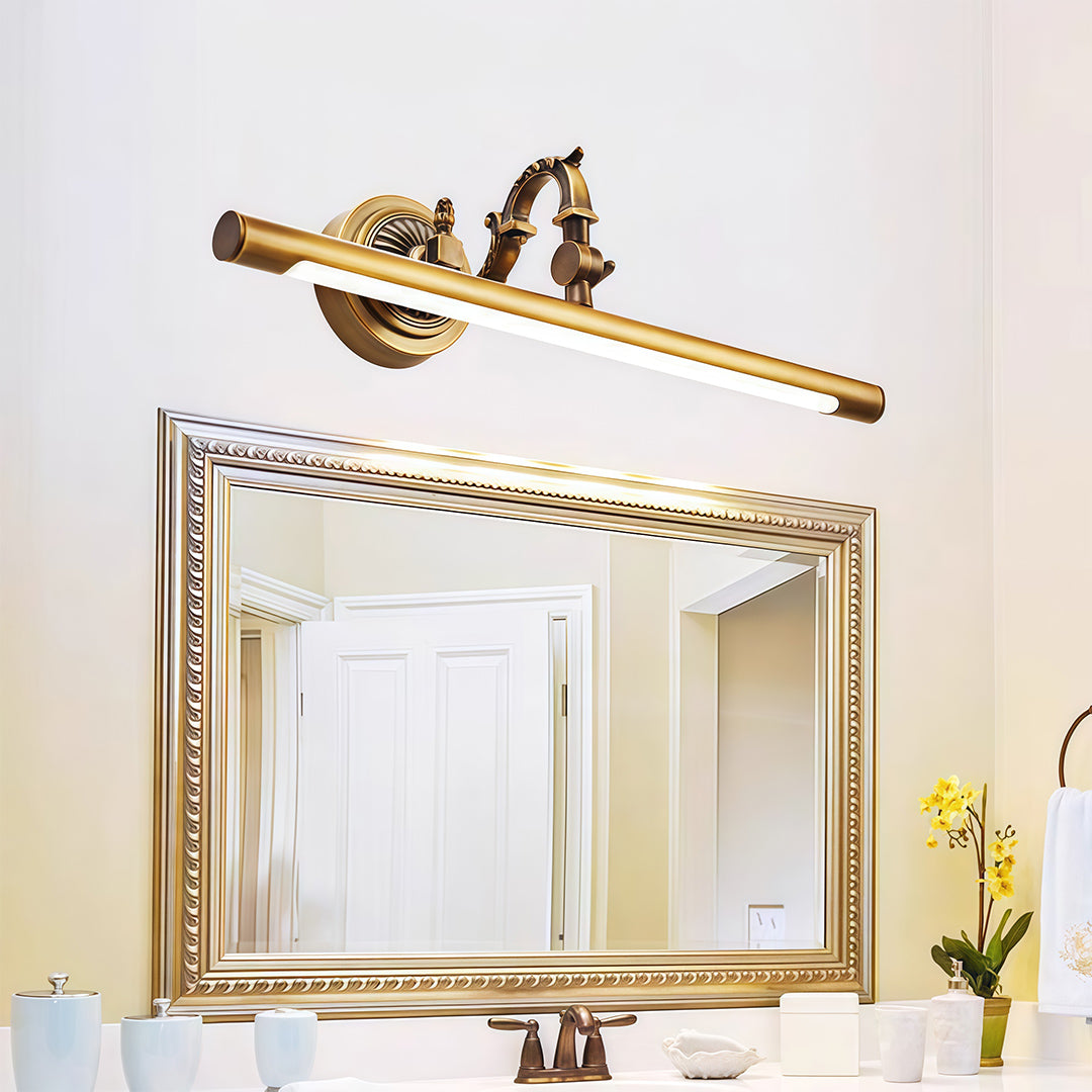 Bathroom LED vanity light illuminating gold-framed mirror above white vanity with marble countertop.