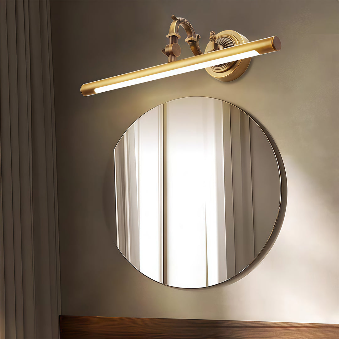 Bathroom LED vanity light suspended above round mirror in moody dark bathroom with warm lighting.