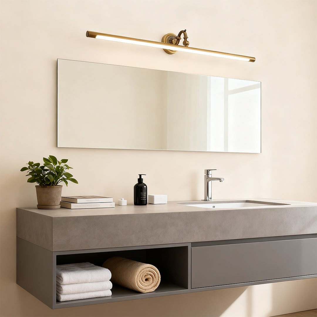 Bathroom LED vanity light creating warm ambient lighting above modern grey vanity with white sink.
