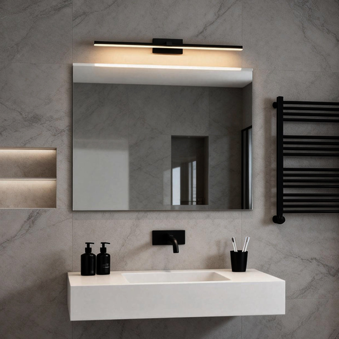 Minimalist bathroom design with rectangular mirror and sleek bathroom lights above vanity.