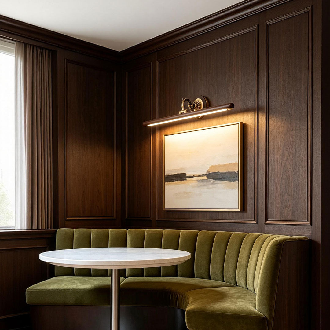 Traditional bathroom vanity bar light fixtures mounted above wall art in a classic dining lounge interior.