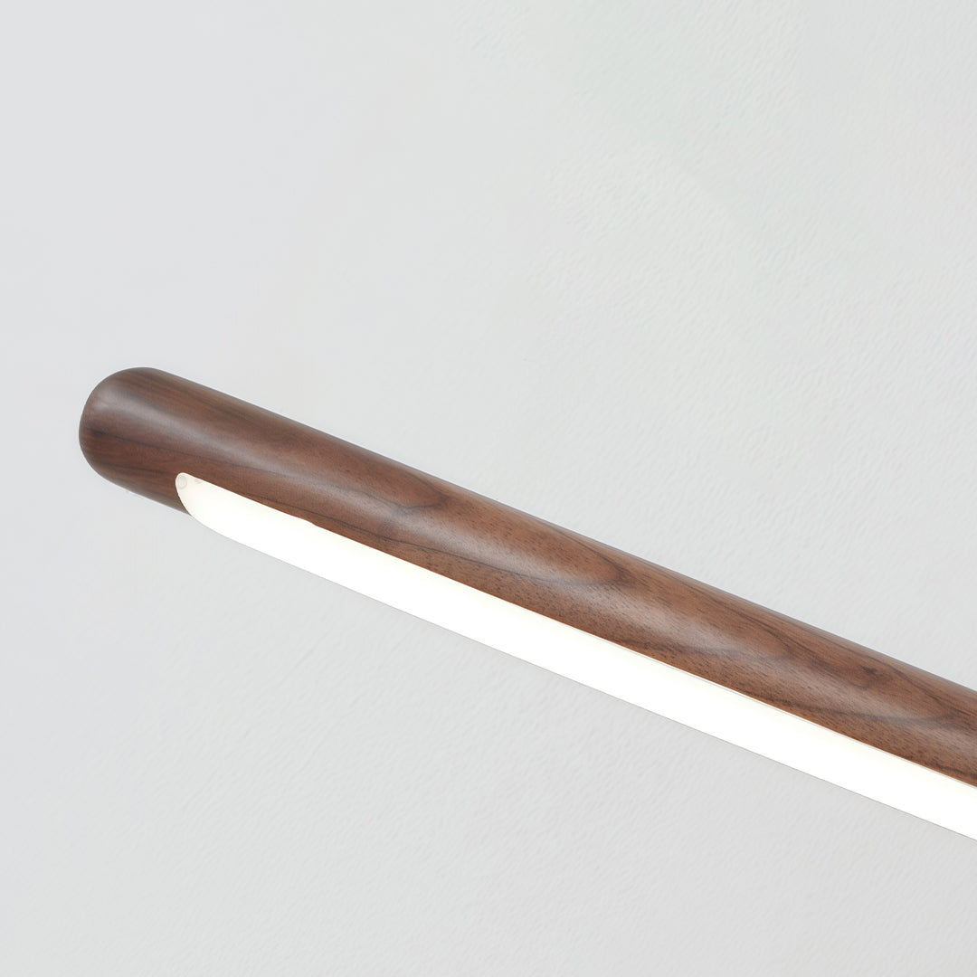 Close-up detail of bathroom vanity bar light fixtures featuring wood grain finish and integrated LED diffuser.
