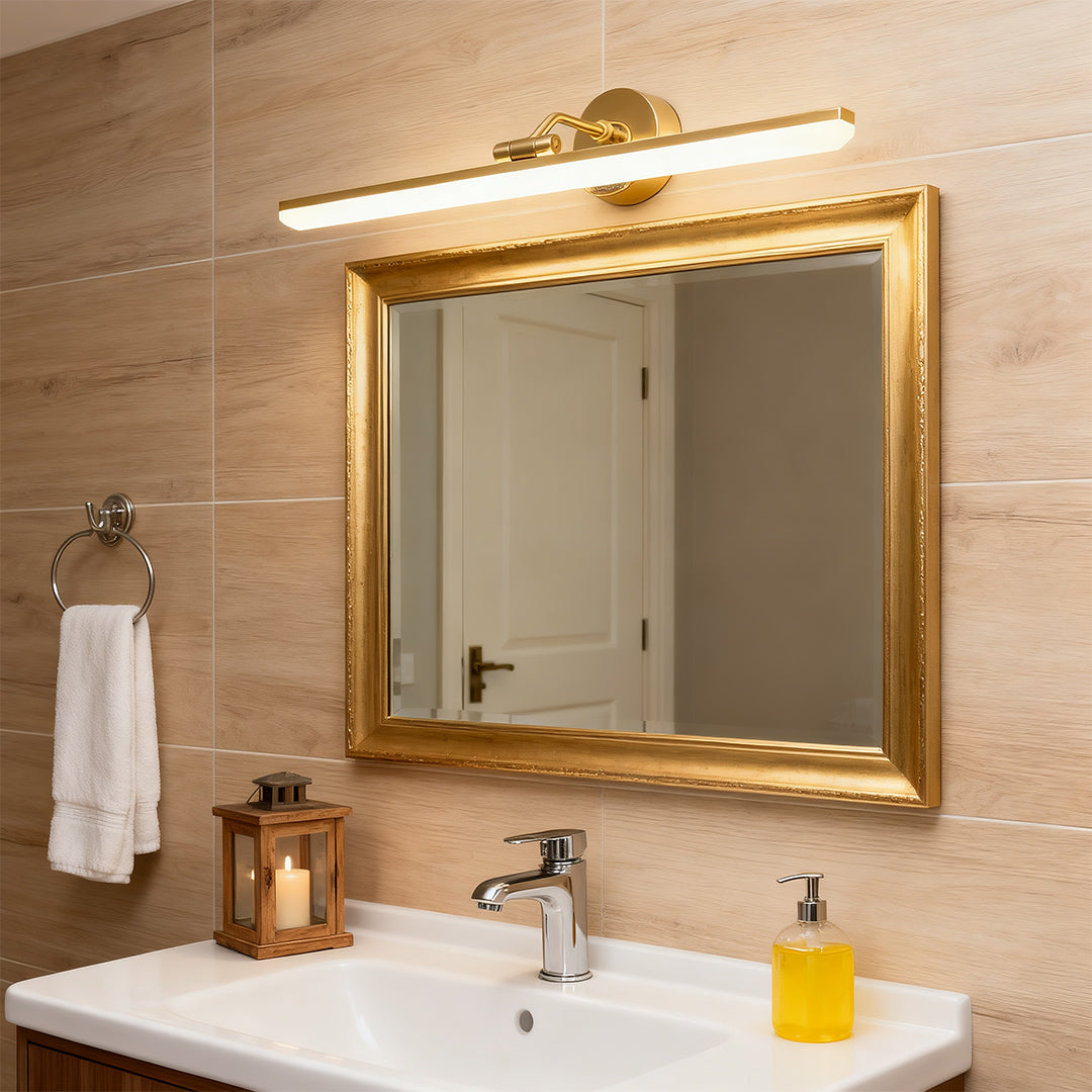 Black and gold bathroom vanity LED light above a sink with a golden-framed mirror, adding elegance to the bathroom.