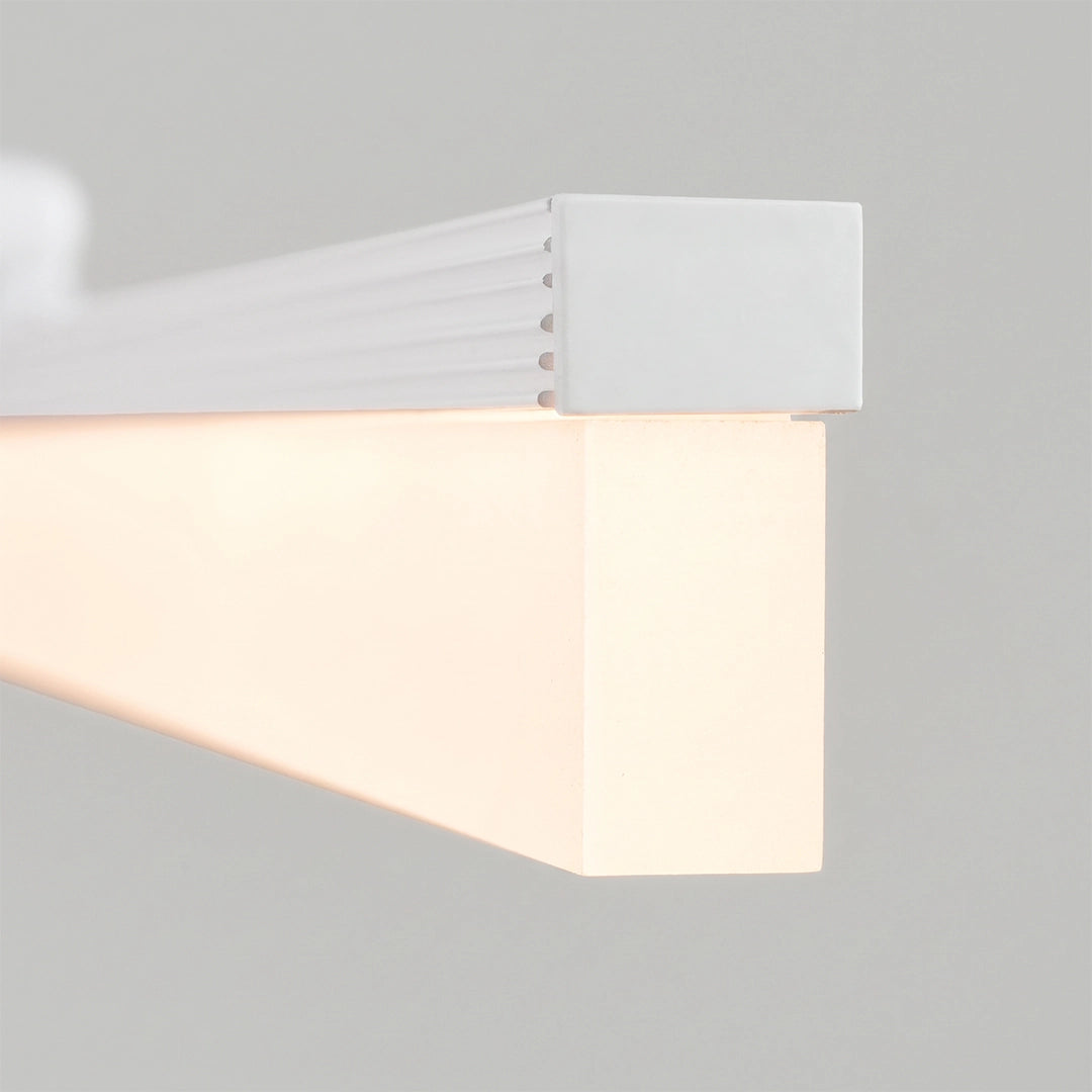 Close-up of the end cap and frosted diffuser on bathroom vanity lights gold style.
