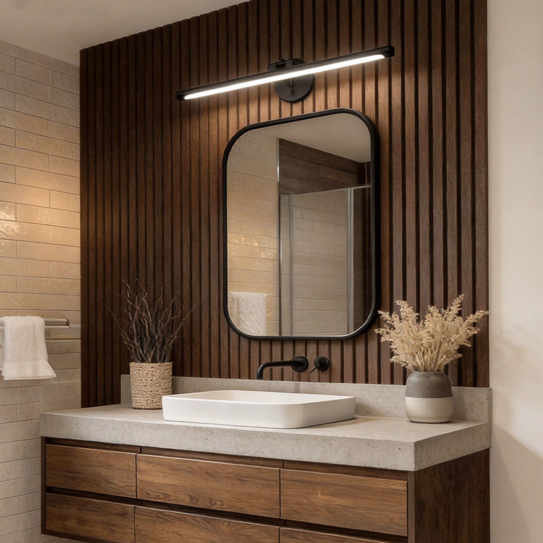 Modern bathroom vanity strip light illuminating the mirror, with a sleek and minimalist design above the sink, creating a bright and clean look.