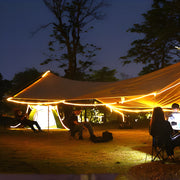 Battery powered LED light strips illuminating outdoor camping tent setup during nighttime