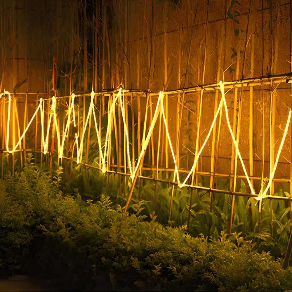 Warm white battery powered LED light strip creating ambient lighting on wooden fence structure