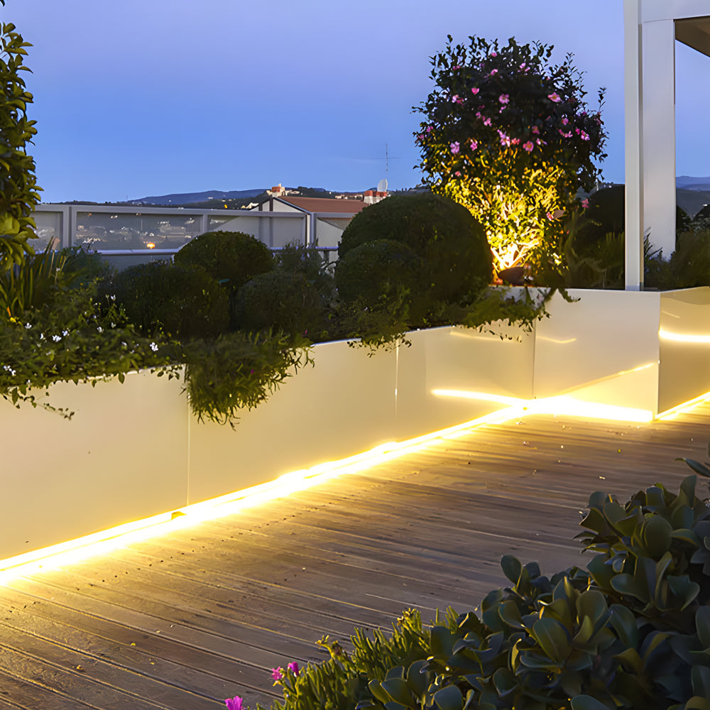 Battery powered LED light strips providing pathway illumination for outdoor walkway at dusk