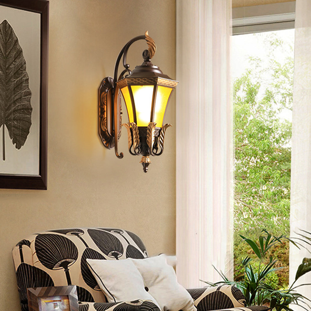 Artistic detail of decorative lantern featuring bronze leaf elements and ornate metalwork typical of classical outdoor lighting