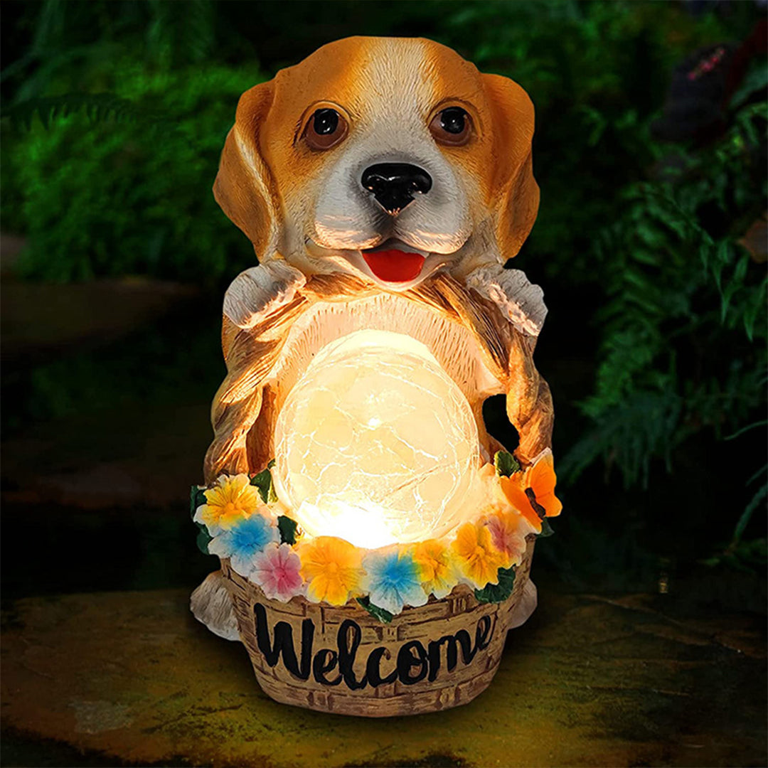 Beagle garden ornament with LED welcome light creating warm evening ambiance outdoors
