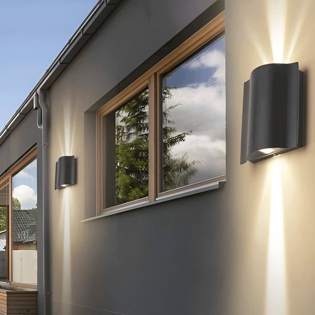 Beam wall light in black, mounted beside a window, providing directional illumination.