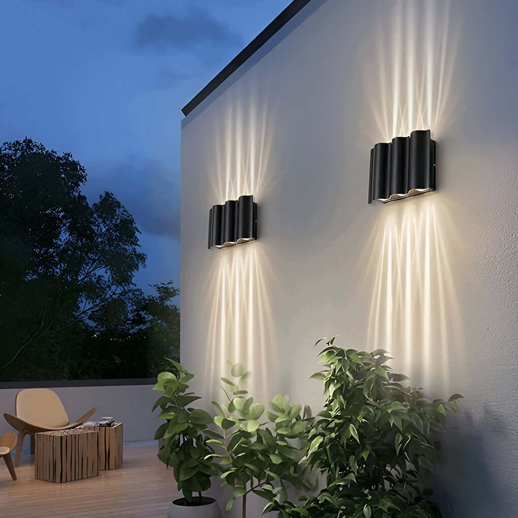 Pair of black beam wall lights mounted on a white exterior wall, providing ambient lighting.