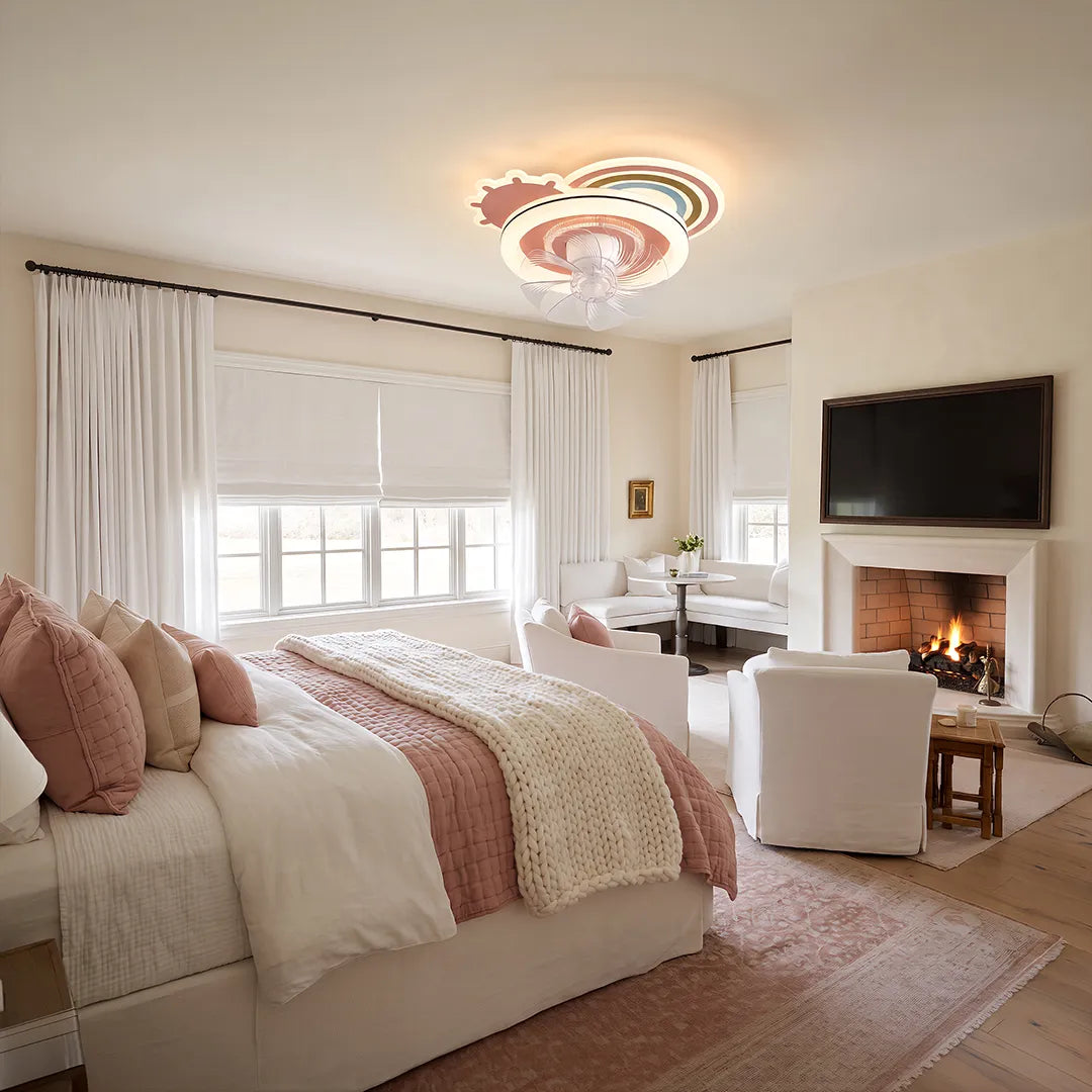 Beautiful ceiling fans with lights mounted in a bedroom with a lounge area, TV, and fireplace.