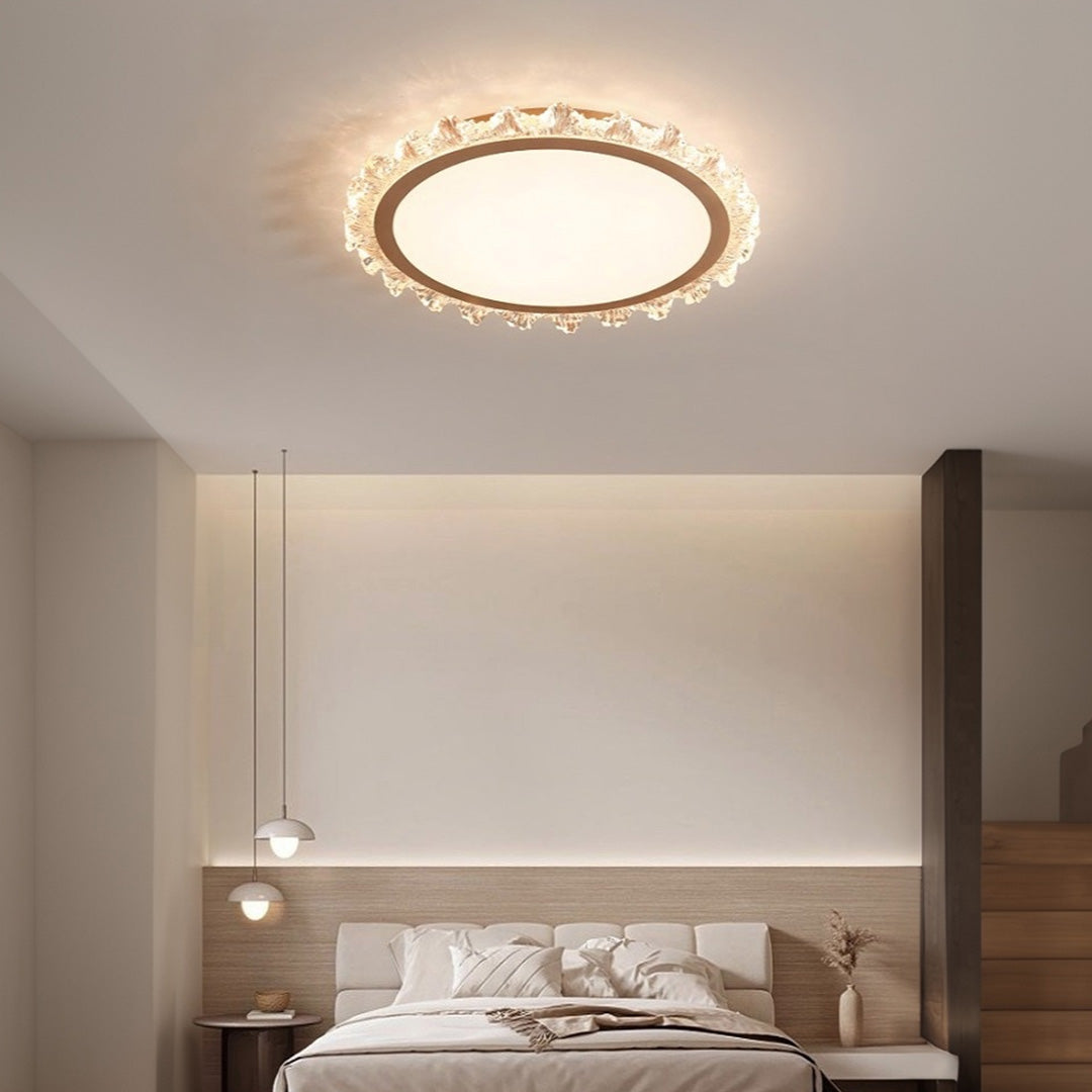 Gold glass shade chandelier illuminating modern bedroom with warm ambient lighting