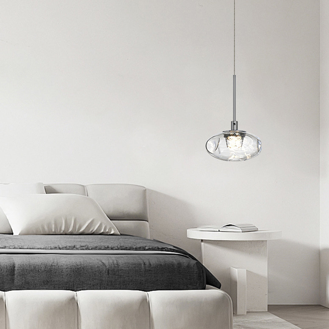 Small glass pendant lights illuminating modern bedroom with crystal shade creating ambient lighting atmosphere
