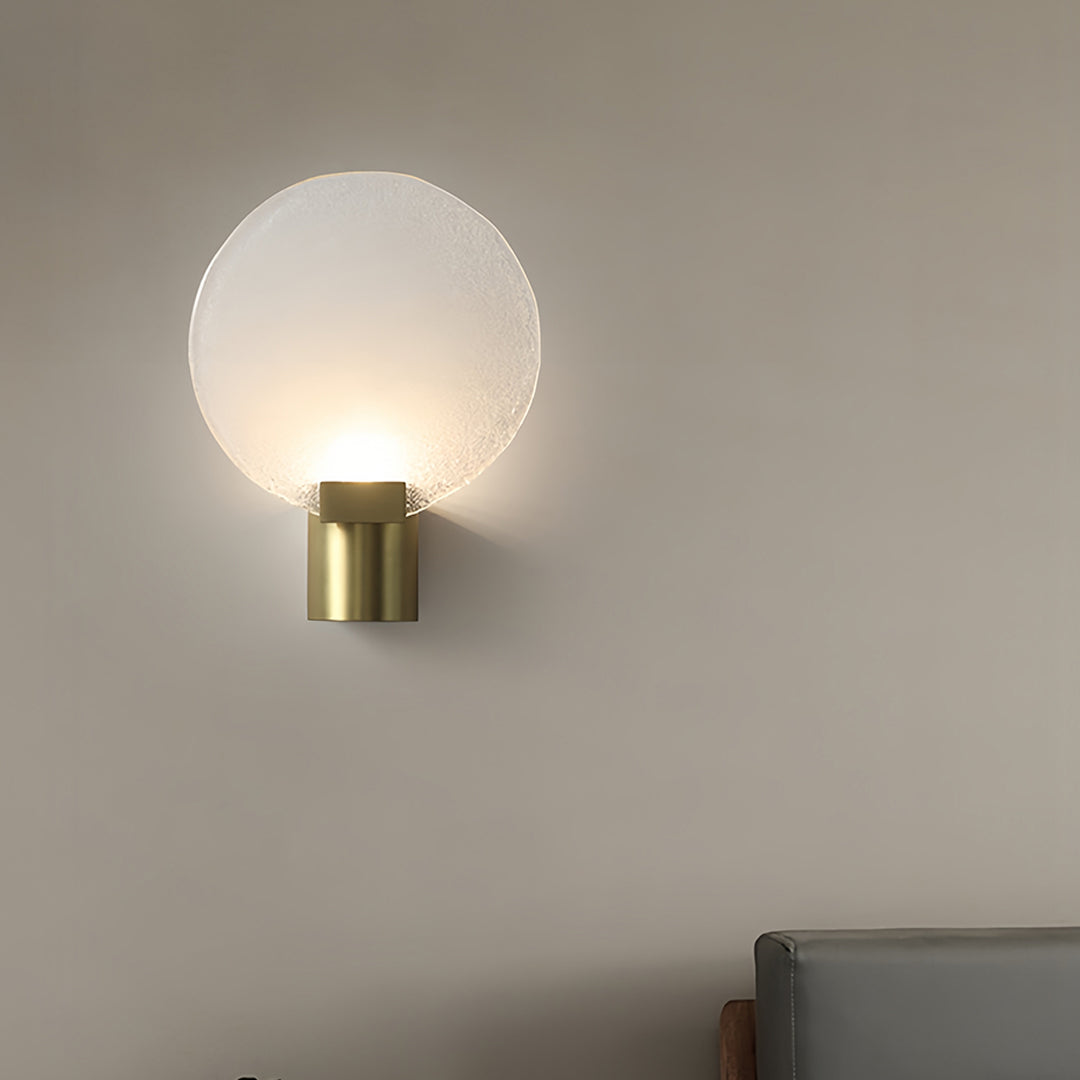 Stylish brass and glass wall lights installed in bedroom setting with warm illumination and modern design