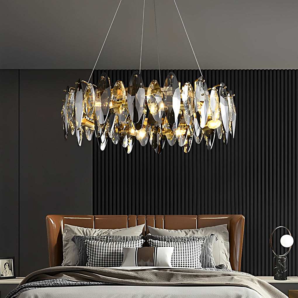 Sophisticated chandelier with crystals creating a warm amber glow in a minimalist bedroom.
