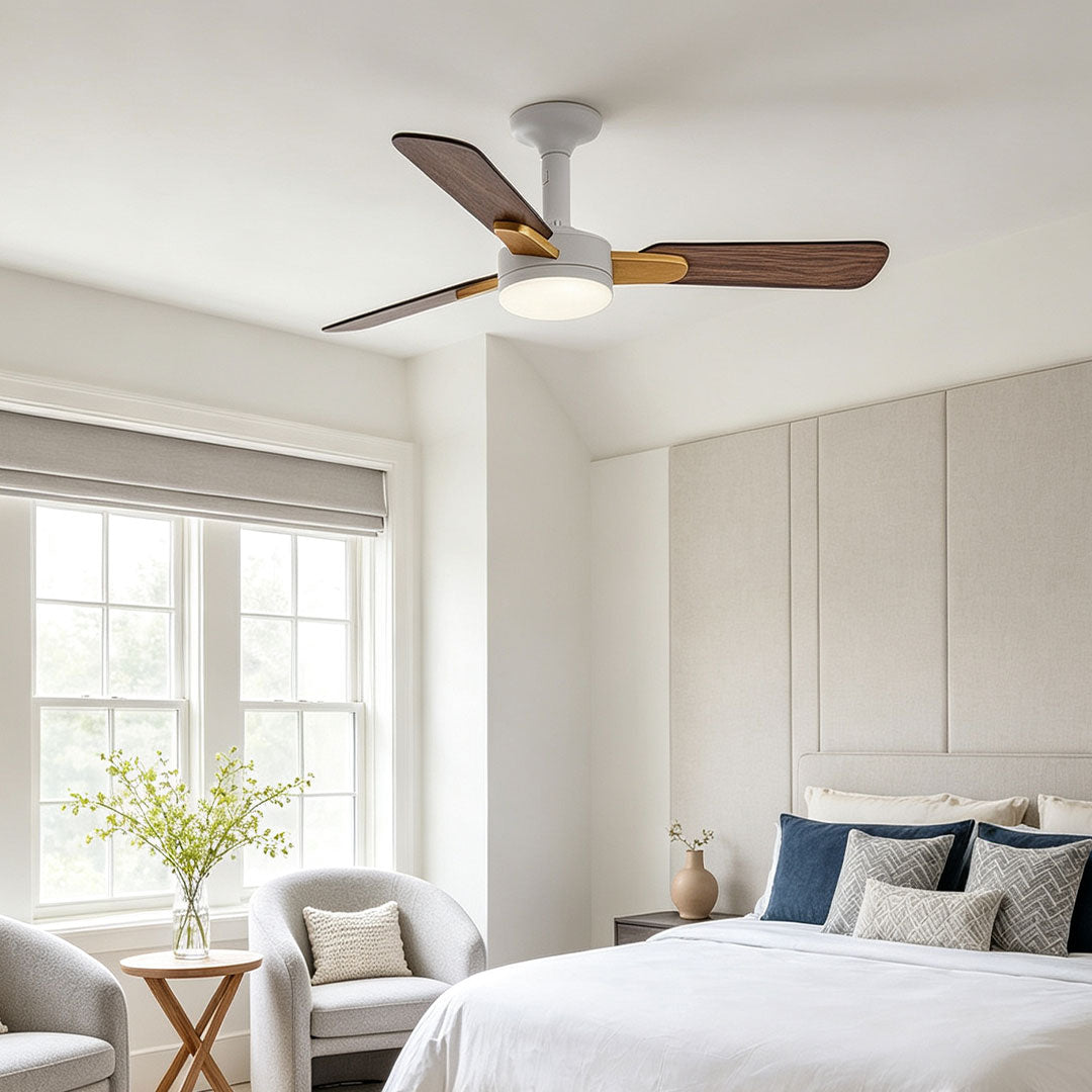 Copper ceiling fan with light installed in a bright bedroom with mixed white and wood blades.