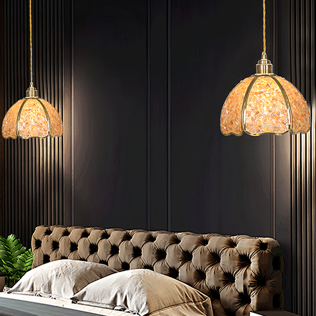 Crystal pendant light creating ambient lighting above luxury tufted headboard in bedroom