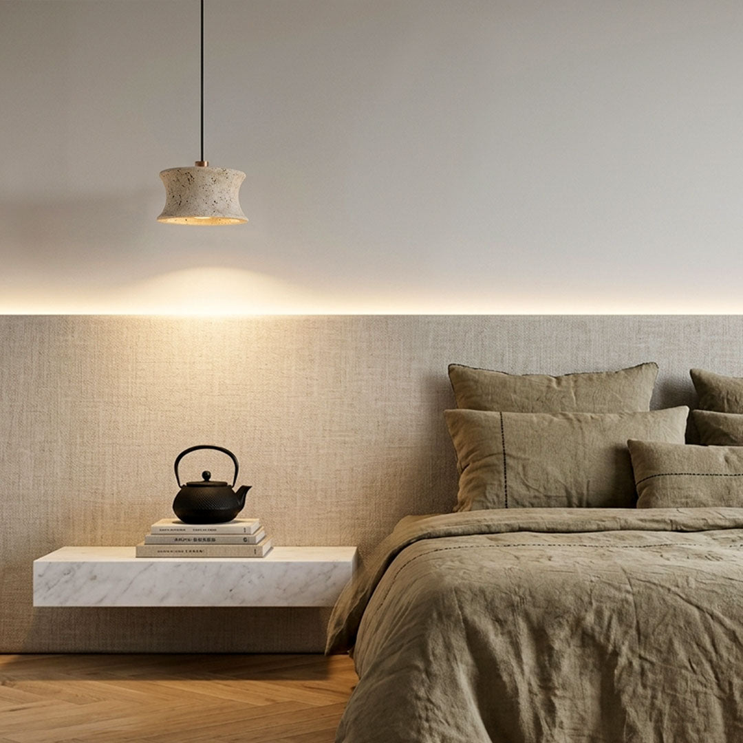 Drum pendant light fixture installed above a floating bedside table with soft ambient lighting.