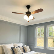 Indoor ceiling fan with light installed in a bedroom with dark wood blades and warm globe lighting.