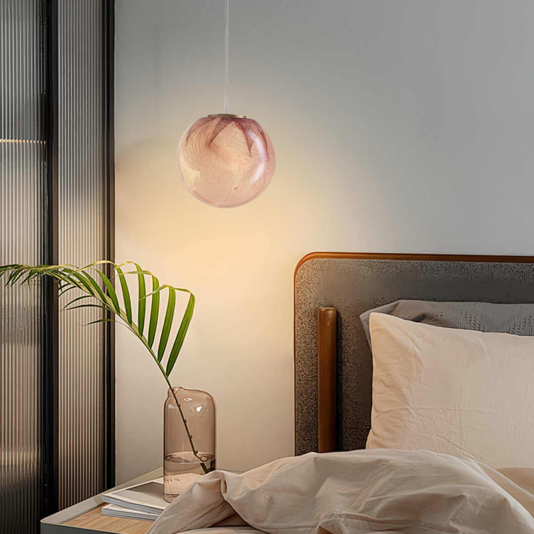 Elegant glass globe pendant lights installed in bedroom setting creating ambient lighting with warm rose gold glass finish