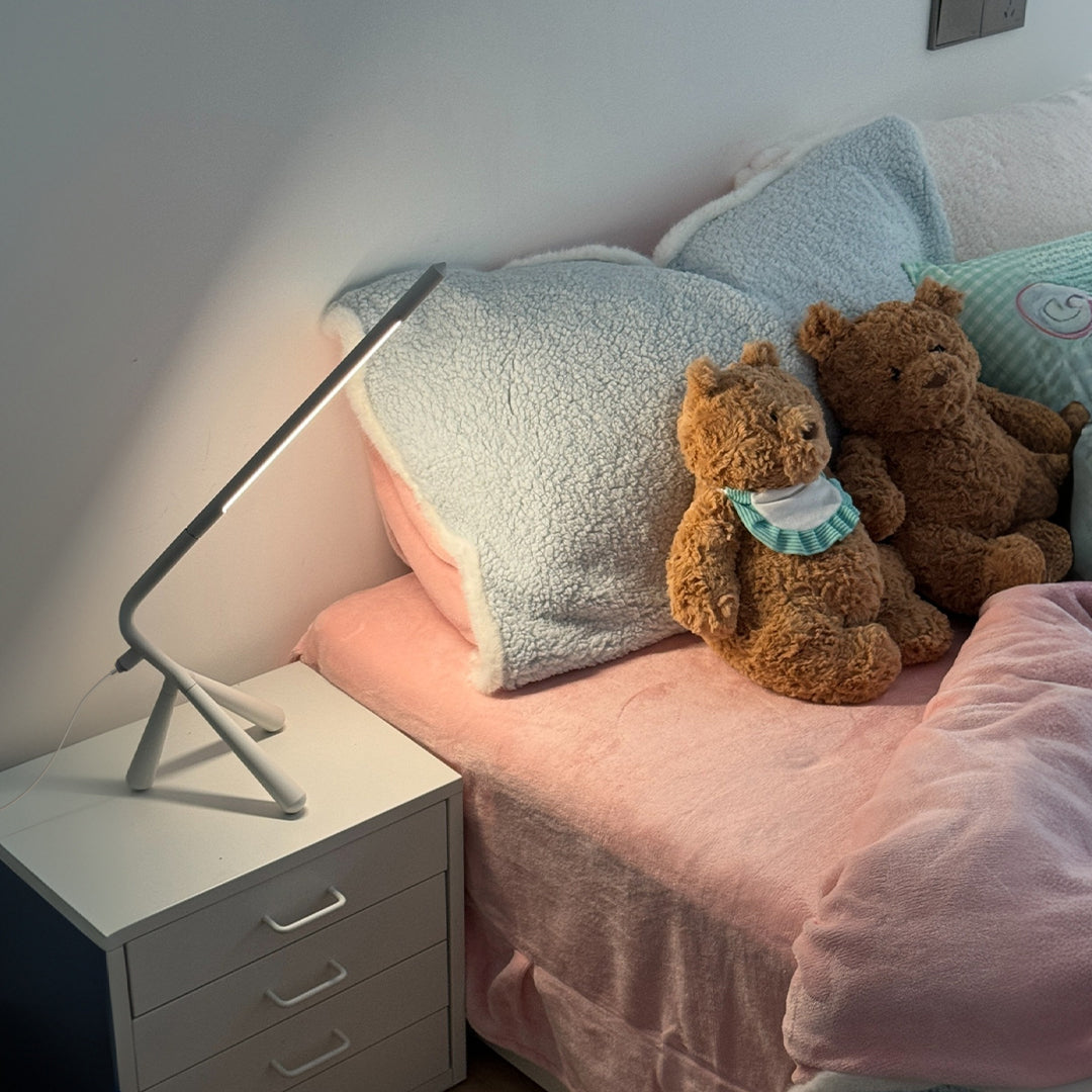 Bedside three legged table lamp with adjustable head creating perfect reading light for comfort