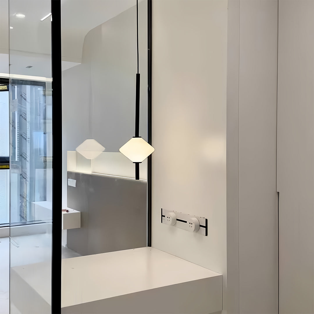 Bedside pendant light providing task lighting in neutral bedroom with brown accent wall