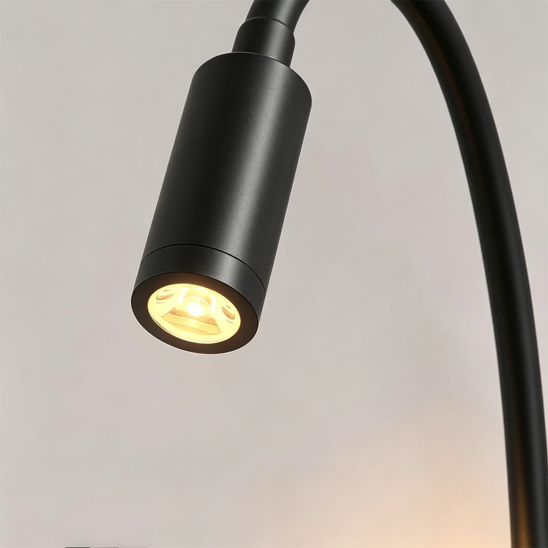 Close-up detail of bedside reading wall lights with black flexible gooseneck spotlight and LED lens.